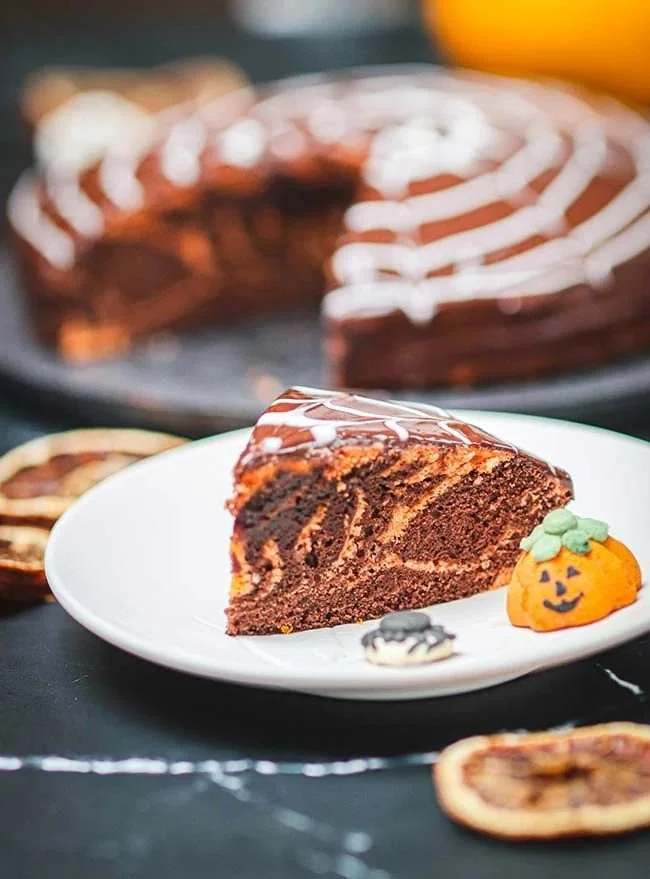 Gâteau marbré moelleux au chocolat et vanille, décoré de copeaux de chocolat.